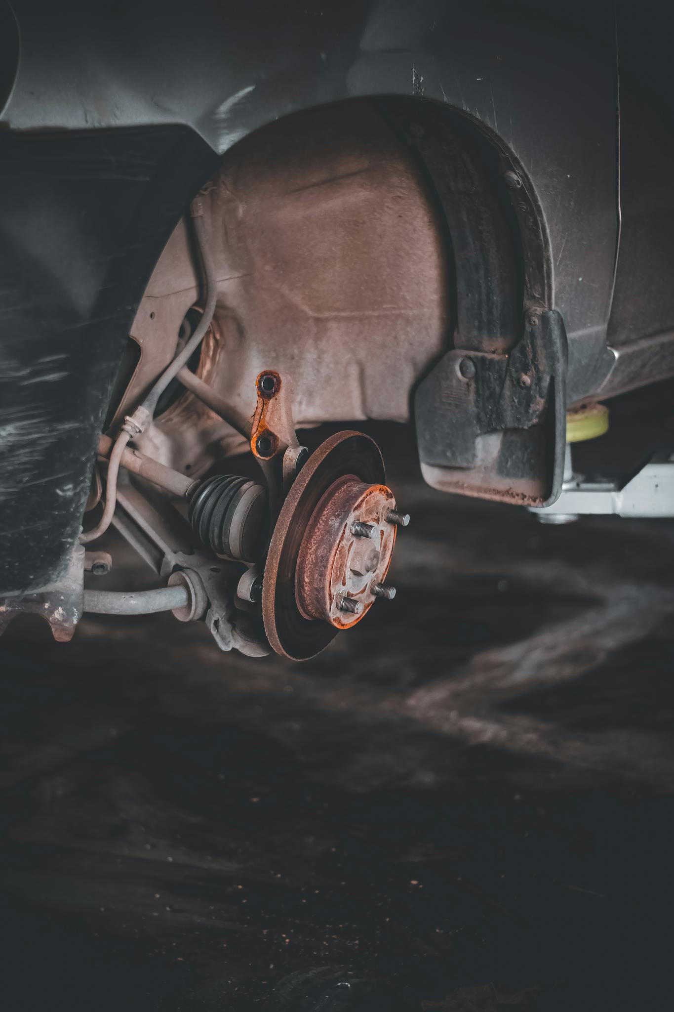 Close-up of a rusty car brake system highlighting repair needs and  maintenance.